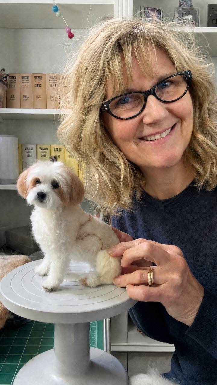 Theresa Kathleen Prosser, founder and artist of FurFelt Creations, with a small white-and-brown dog