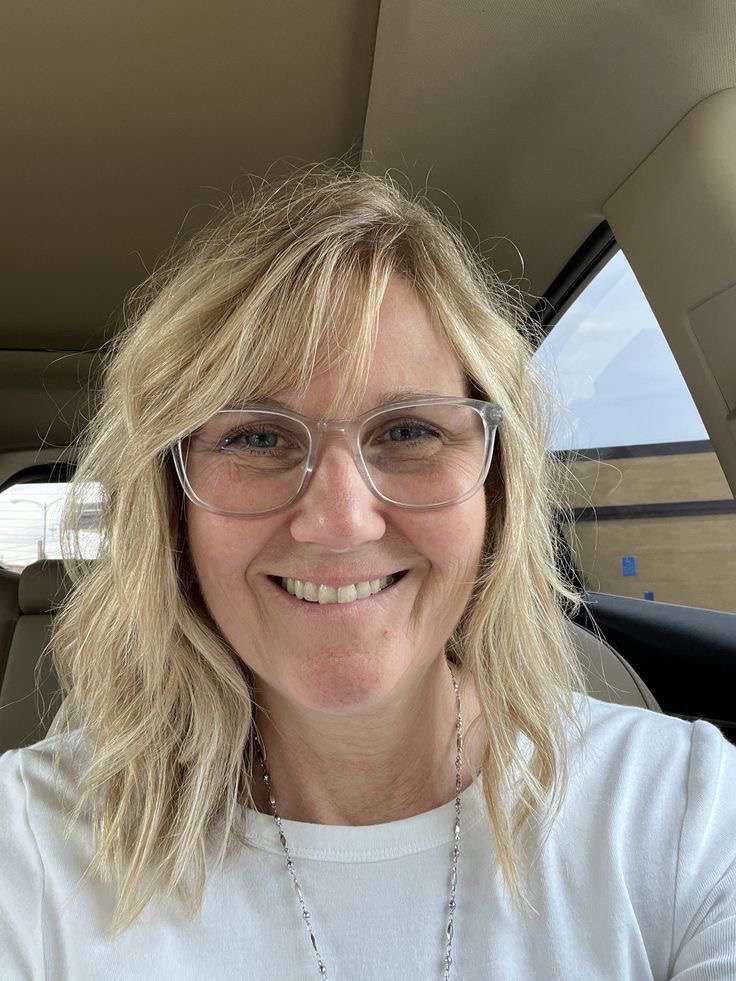 Theresa Kathleen Prosser smiling in a close-up portrait inside a vehicle